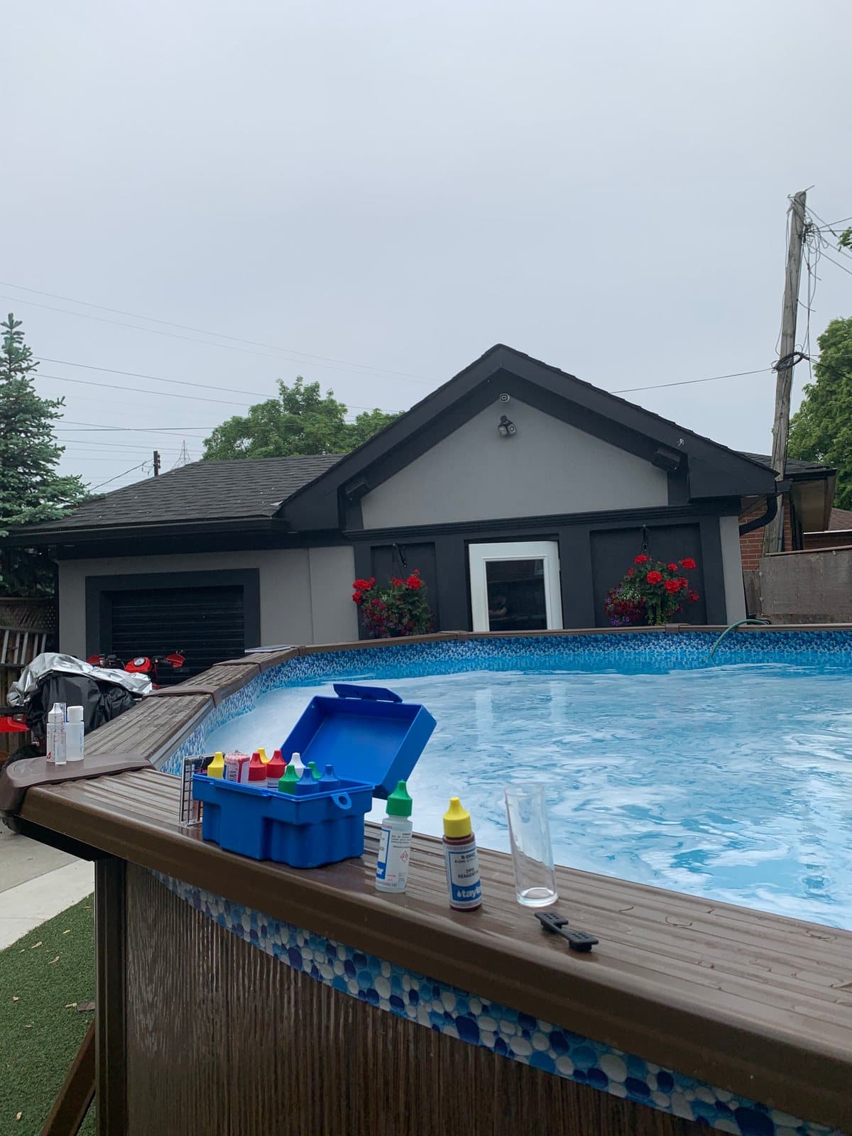 Testing pool water with a chemistry kit at the pool edge
