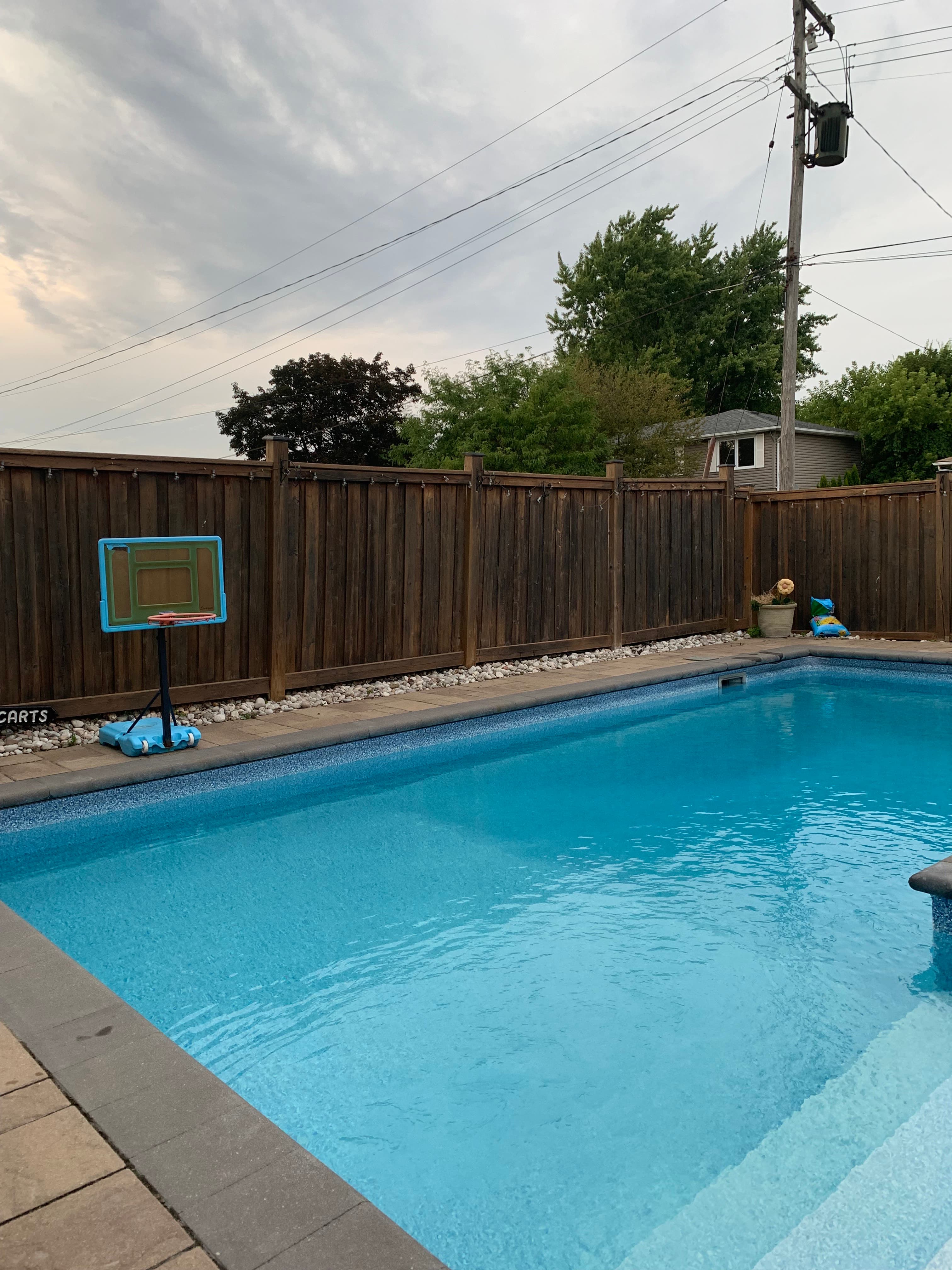 Above-ground pool with wood deck, cleaned and ready for summer